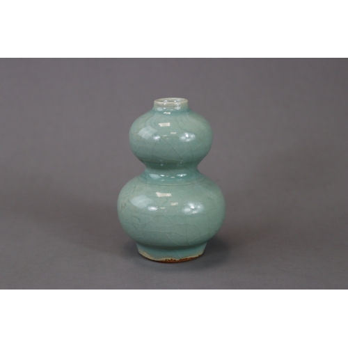 53 - A Longquan Celadon Double-gourd Vase, Song/Yuan dynasty the compressed globular lower bulb rising fr... 