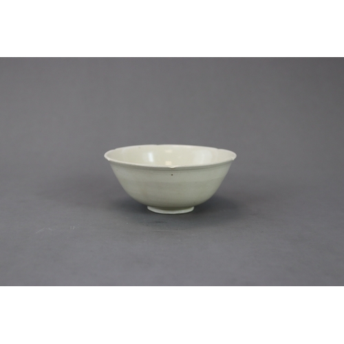 54 - A Ding White-glazed Lobed Cup, Song dynasty the thinly potted deep curved sides rising from a short ... 