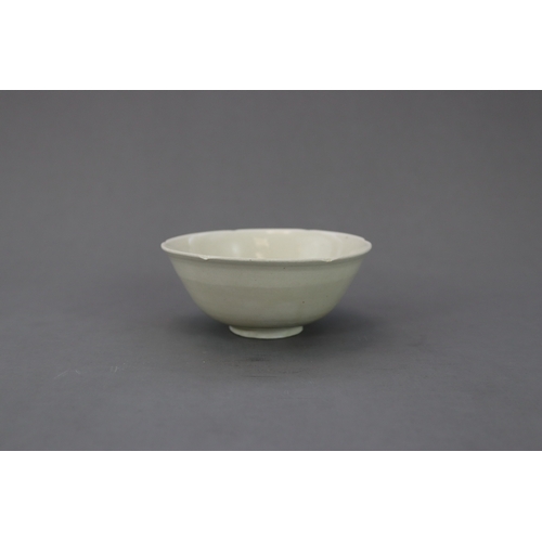 54 - A Ding White-glazed Lobed Cup, Song dynasty the thinly potted deep curved sides rising from a short ... 