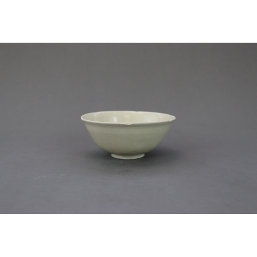 54 - A Ding White-glazed Lobed Cup, Song dynasty the thinly potted deep curved sides rising from a short ... 