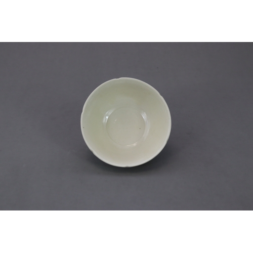 54 - A Ding White-glazed Lobed Cup, Song dynasty the thinly potted deep curved sides rising from a short ... 