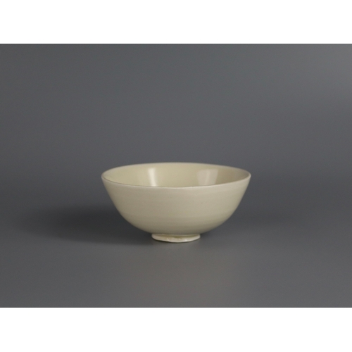 56 - A Ding white-glazed Bowl, Song dynasty with the deep rounded sides rising from a short foot, covered... 