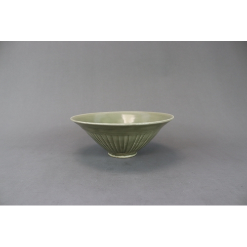 60 - A Moulded Yaozhou Celadon Conical Bowl, Song dynasty with deep flared sides rising to the rounded ri... 