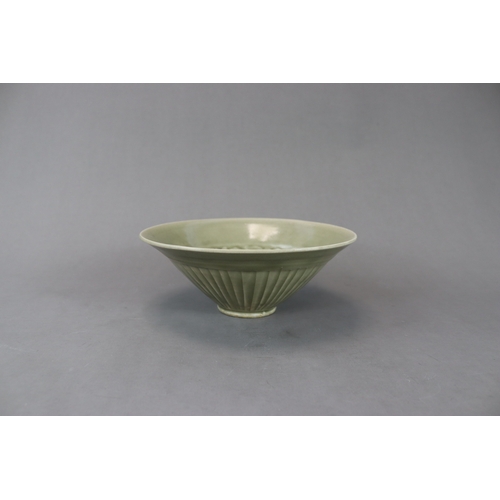 60 - A Moulded Yaozhou Celadon Conical Bowl, Song dynasty with deep flared sides rising to the rounded ri... 