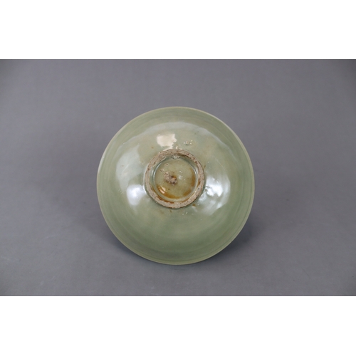 61 - A Yaozhou Celadon Floral Dish, Song dynasty finely potted, with angled sides rising from a broad bas... 