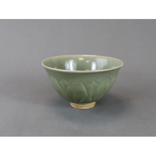 62 - A Carved Yaozhou Celadon Lotus Bowl, Song dynasty the deep gently curved sides rising from a short s... 