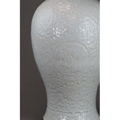 77 - A Carved White Glazed Vase, Guanyinping, 18/19th century Of slender baluster form with waisted neck,... 