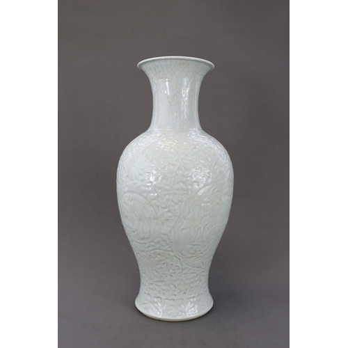 77 - A Carved White Glazed Vase, Guanyinping, 18/19th century Of slender baluster form with waisted neck,... 