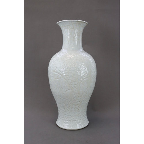 77 - A Carved White Glazed Vase, Guanyinping, 18/19th century Of slender baluster form with waisted neck,... 