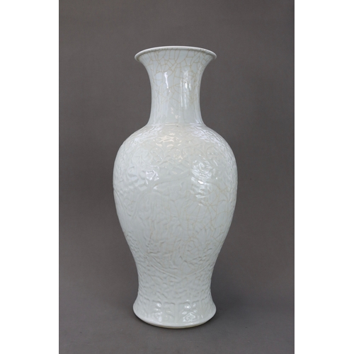 77 - A Carved White Glazed Vase, Guanyinping, 18/19th century Of slender baluster form with waisted neck,... 