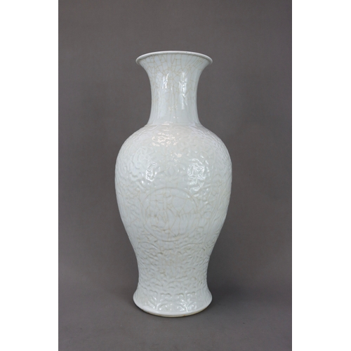 77 - A Carved White Glazed Vase, Guanyinping, 18/19th century Of slender baluster form with waisted neck,... 