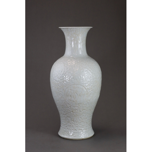 77 - A Carved White Glazed Vase, Guanyinping, 18/19th century Of slender baluster form with waisted neck,... 