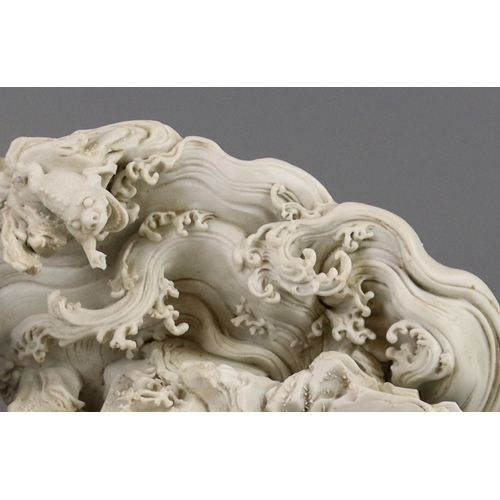 78 - A Fine Biscuit Group of Liuhai and his Toad, 18th century, the unglazed biscuit finely carved with e... 