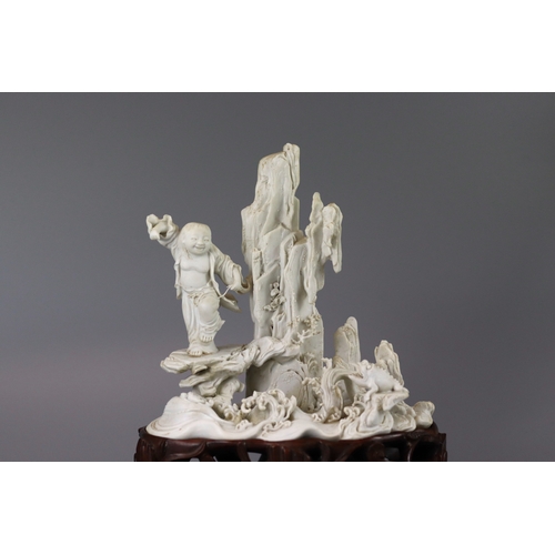 78 - A Fine Biscuit Group of Liuhai and his Toad, 18th century, the unglazed biscuit finely carved with e... 