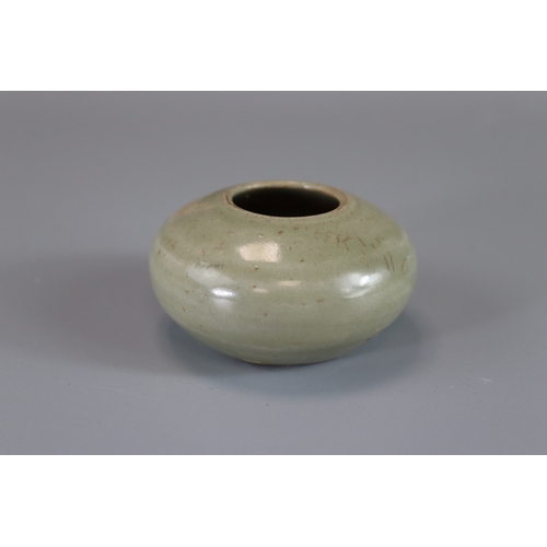 8 - A Yue Celadon Waterpot, Tang dynasty rounded sides from flat base to incurved rim, overall in transl... 