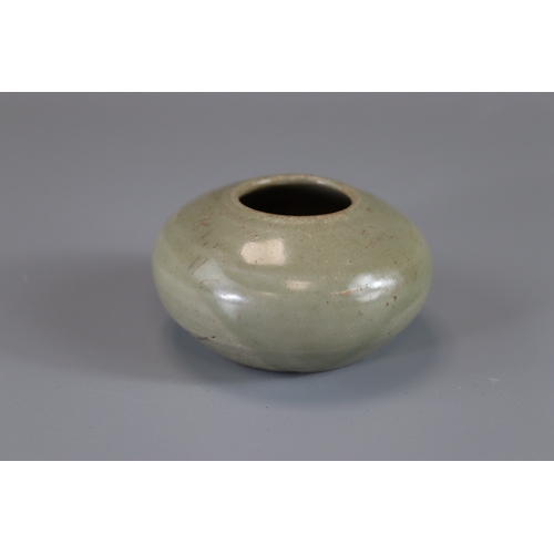 8 - A Yue Celadon Waterpot, Tang dynasty rounded sides from flat base to incurved rim, overall in transl... 