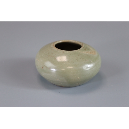 8 - A Yue Celadon Waterpot, Tang dynasty rounded sides from flat base to incurved rim, overall in transl... 