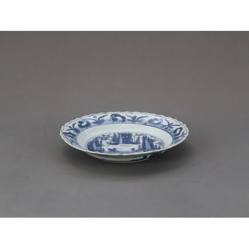 80 - A Barbed Blue and White Landscape Dish, 16th century,  well painted  in deep cobalt, with a rider cr... 