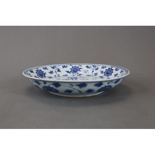 83 - A Blue and White Dish with Lotus, six character mark of Jiajing and of the period, well painted in s... 