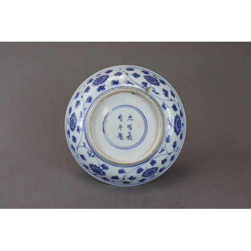 83 - A Blue and White Dish with Lotus, six character mark of Jiajing and of the period, well painted in s... 