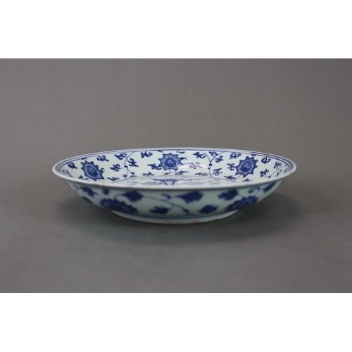 83 - A Blue and White Dish with Lotus, six character mark of Jiajing and of the period, well painted in s... 