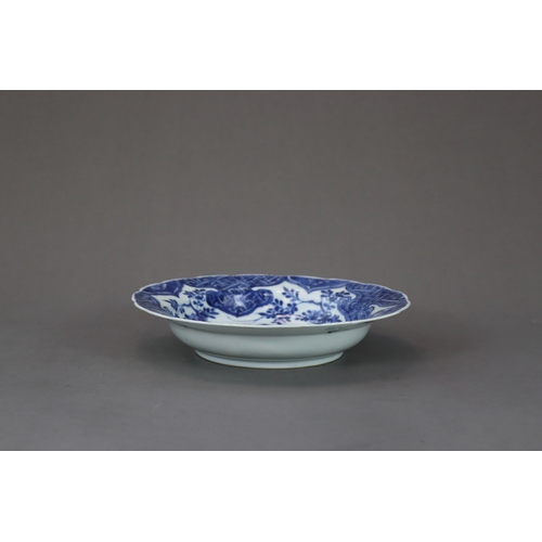 88 - A Blue and White Pheasant Dish, Kangxi,  of small basin form, painted in intense cobalt with a centr... 