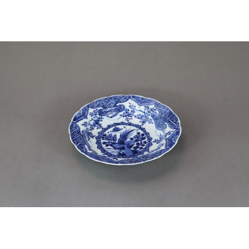 88 - A Blue and White Pheasant Dish, Kangxi,  of small basin form, painted in intense cobalt with a centr... 