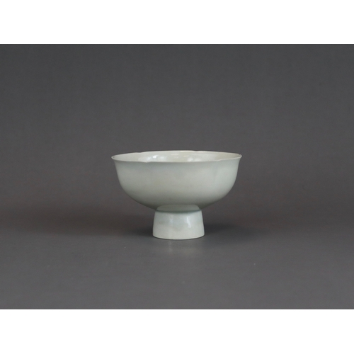 9 - A Qingbai Lobed Cup, Song dynasty with rounded sides rising from a tall splayed foot and flaring to ... 