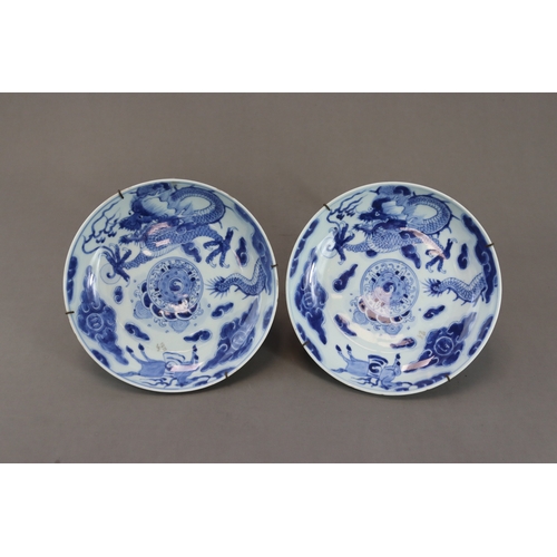 94 - A Pair of Blue and White Dragon Dishes, Yongzheng, well painted in soft clear tones around the well ... 