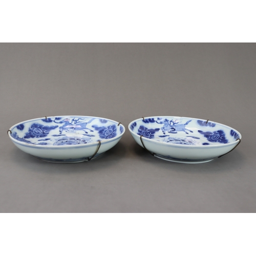 94 - A Pair of Blue and White Dragon Dishes, Yongzheng, well painted in soft clear tones around the well ... 