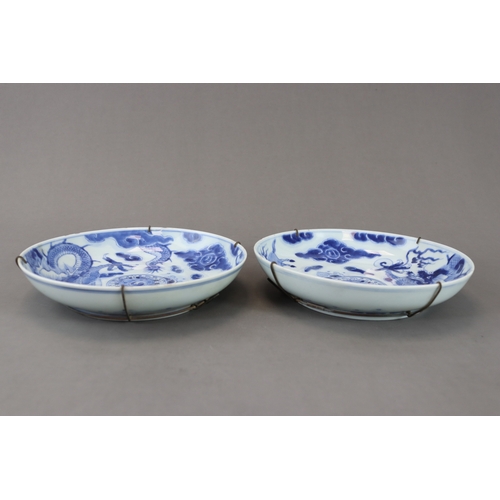 94 - A Pair of Blue and White Dragon Dishes, Yongzheng, well painted in soft clear tones around the well ... 