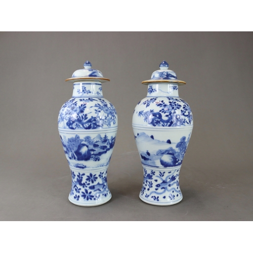 95 - A Pair of Blue and White Vases and Covers, Kangxi of slender baluster form, well painted around the ... 