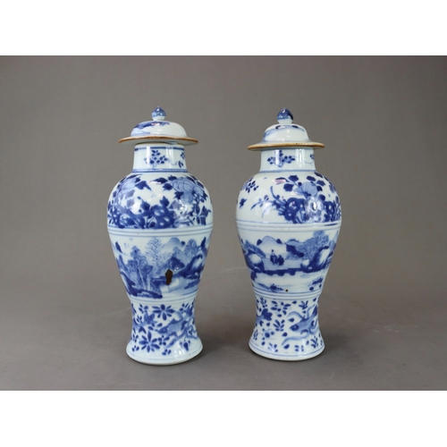 95 - A Pair of Blue and White Vases and Covers, Kangxi of slender baluster form, well painted around the ... 