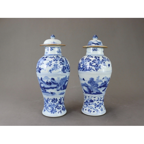 95 - A Pair of Blue and White Vases and Covers, Kangxi of slender baluster form, well painted around the ... 