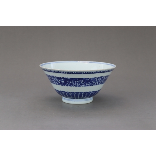 98 - A Blue and White Bowl,c.1730, The flared sides decorated in inky tones on the exterior with a centra... 