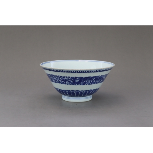 98 - A Blue and White Bowl,c.1730, The flared sides decorated in inky tones on the exterior with a centra... 