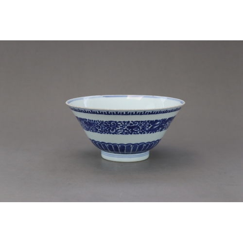 98 - A Blue and White Bowl,c.1730, The flared sides decorated in inky tones on the exterior with a centra... 