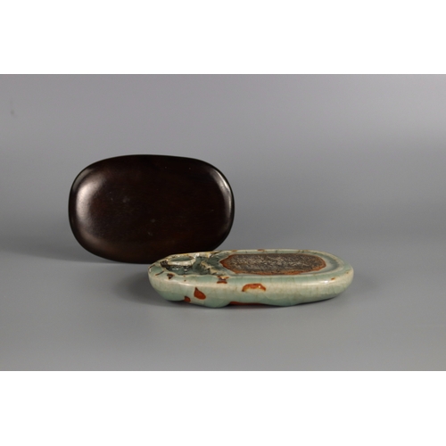 1 - A Longquan Celadon Inkstone, Ming dynasty of double-sided oval form with a shallow indented ovoid we... 