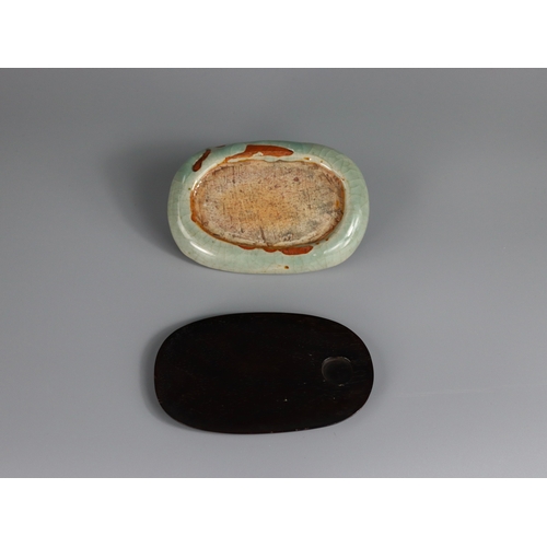 1 - A Longquan Celadon Inkstone, Ming dynasty of double-sided oval form with a shallow indented ovoid we... 