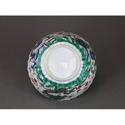 104 - A 'famille verte' Dragon Bowl, Kangxi,  the fluted sides strikingly enamelled with three fierce drag... 