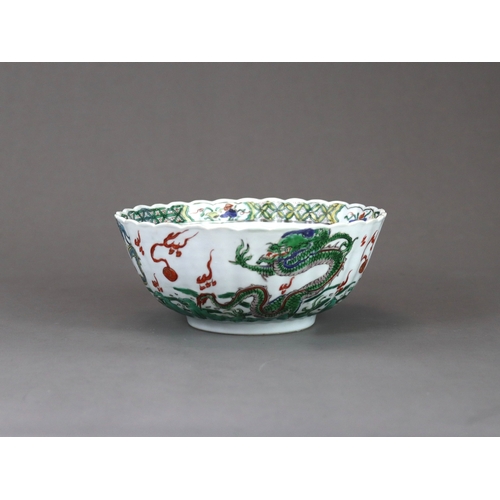 104 - A 'famille verte' Dragon Bowl, Kangxi,  the fluted sides strikingly enamelled with three fierce drag... 