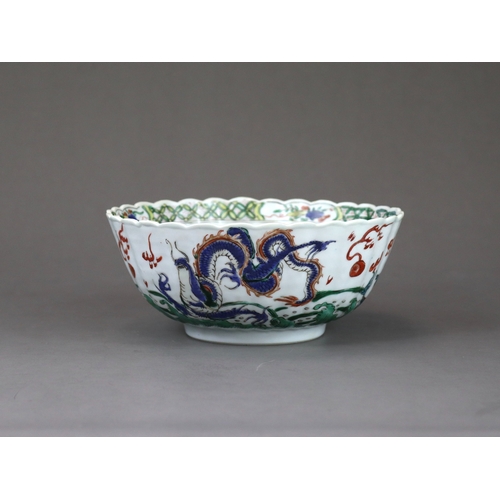 104 - A 'famille verte' Dragon Bowl, Kangxi,  the fluted sides strikingly enamelled with three fierce drag... 