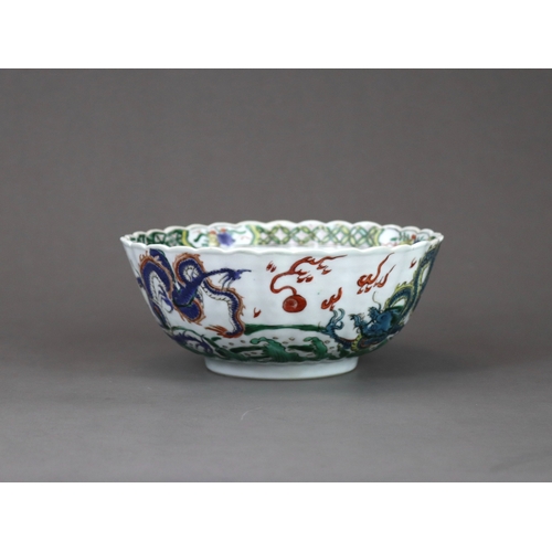 104 - A 'famille verte' Dragon Bowl, Kangxi,  the fluted sides strikingly enamelled with three fierce drag... 