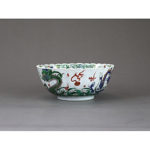 104 - A 'famille verte' Dragon Bowl, Kangxi,  the fluted sides strikingly enamelled with three fierce drag... 