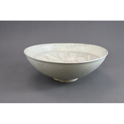 11 - A Cizhou Carved Floral Dish, Jin dynasty the deep rounded sides flaring from the straight foot to th... 