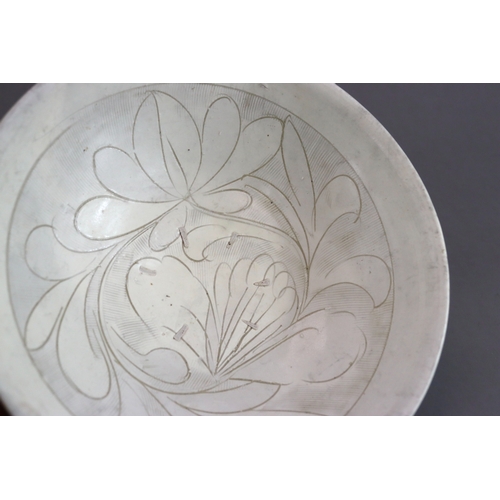 11 - A Cizhou Carved Floral Dish, Jin dynasty the deep rounded sides flaring from the straight foot to th... 