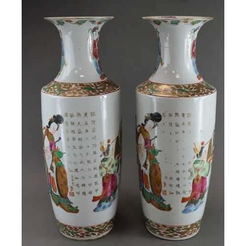 121 - A Large Pair of 'Canton famille rose' Vases with Figures, 19th century, of tall rouleau form, finely... 