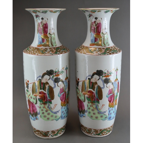 121 - A Large Pair of 'Canton famille rose' Vases with Figures, 19th century, of tall rouleau form, finely... 