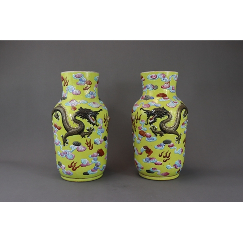 129 - An Unusual Pair of Moulded Dragon Vases, 19th century, The cylindrical sides, rounded shoulder and s... 