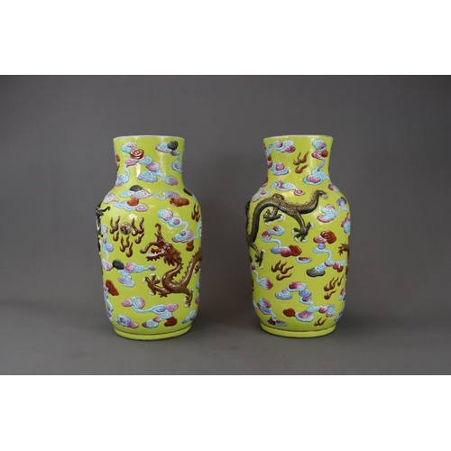 129 - An Unusual Pair of Moulded Dragon Vases, 19th century, The cylindrical sides, rounded shoulder and s... 